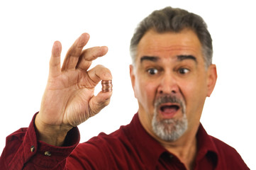 Man holding coins with look of shock on his face