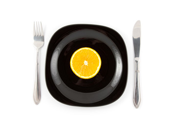 Orange slice on black plate