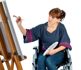 girl painting picture on wheelchair
