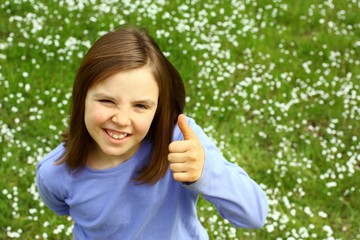 Cute little girl with thumb up