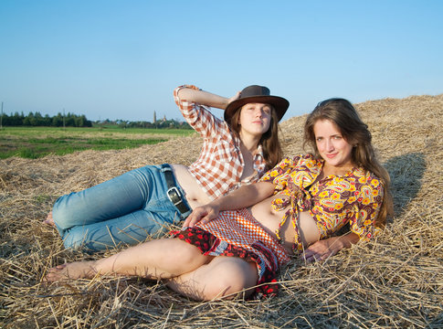Girls laying in hay