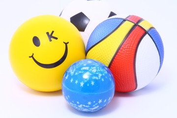 various colorful toy balls on white