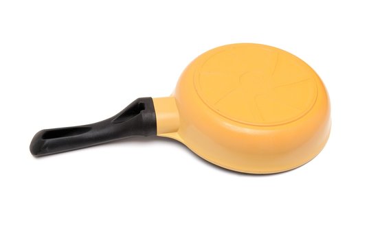 Black and yellow frying pan upside down isolated