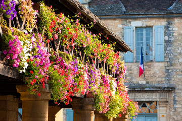 Geraniums and a French flag.