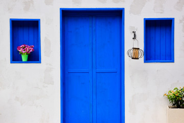 Modern house with colorful blue door and window