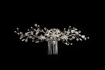 Diamond comb for hair on a black background with reflexion © kelley