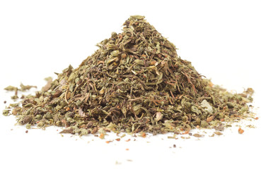 Heap of dried herbal seasoning, macro shot, isolated