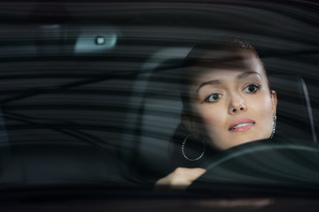 young pretty woman driving car