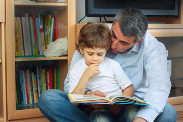Fototapeta na wymiar man and little boy reading book