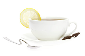 white cup, a spoon and a lemon isolated on white