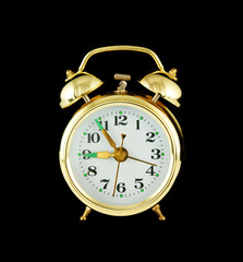 Retro alarm clock isolated on black background