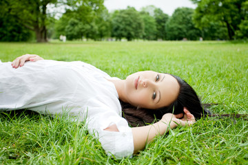 Beautiful woman laying on grass