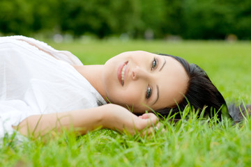 POrtrait of sexy woman laying on grass