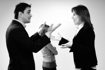 unhappy child and her busy parents in conflict