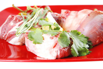 uncooked meat medallion on red