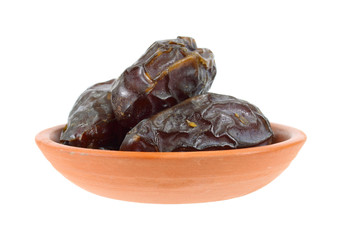 Medjool dates in a terra cotta dish