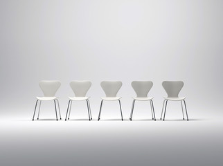Row of five white plastic and metal chairs
