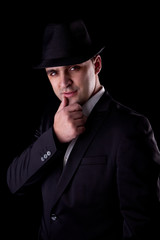 man with his hand to his lips in a seductive pose