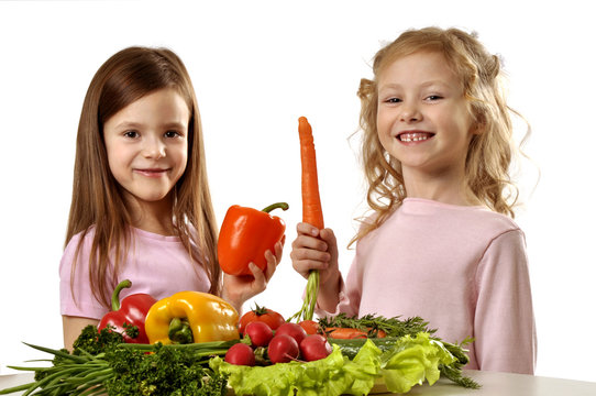 Little girls with bunch of vegetables