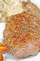 Cut of meat with some sauce close up