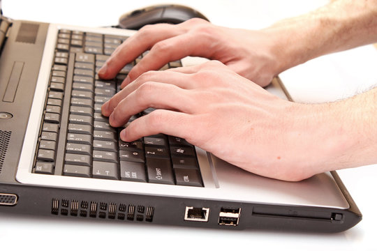 Closeup of male fingers typing a  document on the black laptop