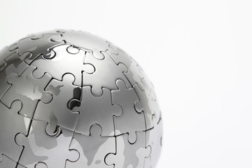 Metal puzzle globe close-up,  isolated on white background