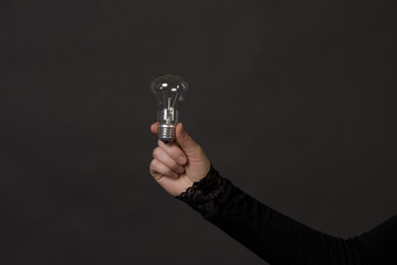Woman hand with electric bulb