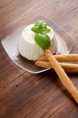 dish with ricotta basil and artisanal breadstick