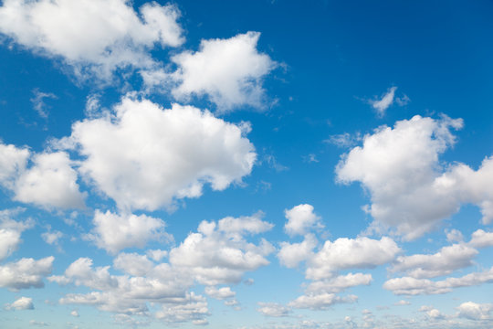 White, fluffy clouds in blue sky. Background from clouds.