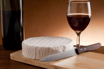 camembert with knife and red wine