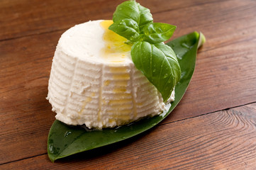 ricotta with basil on wood background