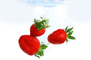 rote erdbeeren fallen ins wasser