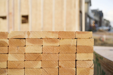 Closeup of Stacks of Lumber at a Construction Site - obrazy, fototapety, plakaty