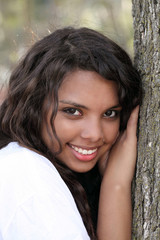 Young mixed teen girl outdoor portrait tree