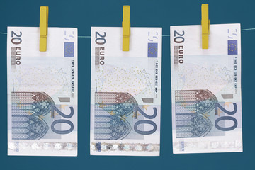 Three Euro bills hanging on clothesline