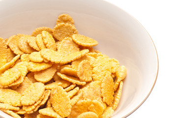 Corn-flakes on white plate.
