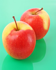 Juicy red apple on green