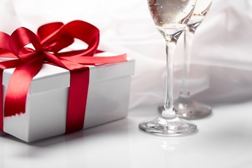 Gift decorated with bow, glass wine