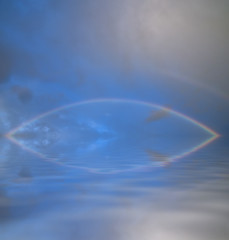 Full Rainbow over calm ocean water