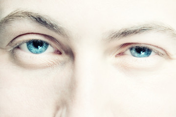 highlighted young man's blue eyes with selective focus