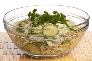 Salad in a glass bowl from cabbage of a cucumber and the fennel,