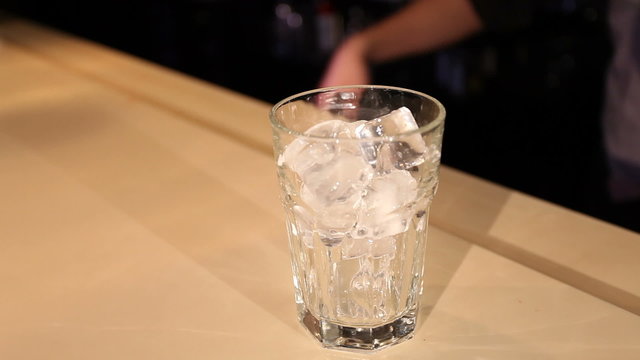 filling a glass full  with ice