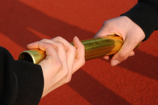 Hände mit Staffelstab zum Erfolg - Powered by Adobe