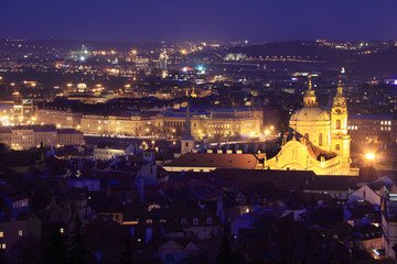 Fototapeta na wymiar The night View to bright Prague with St. Nicholas' Cathedral