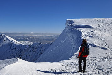 Mountaineer on snowy summit