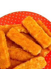 Fish fingers on the red plate. Isolation