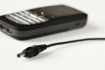 Cell phone charger and cell phone on white background