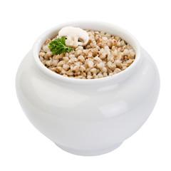 pot with boiled buckwheat decorated with mushroom and parsley