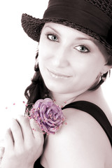 Portrait of teenage girl in hat and with rose in her hand