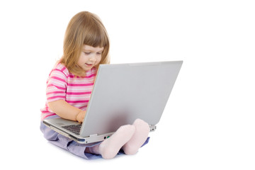 Fototapeta premium Little smiling girl with laptop